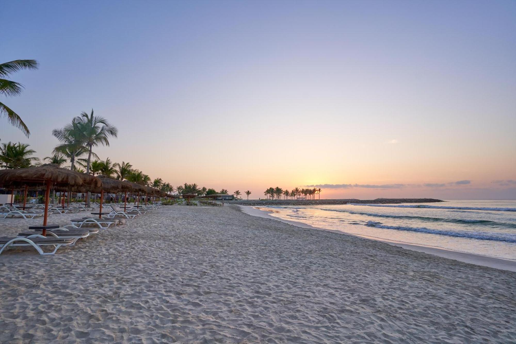 Salalah Rotana Resort Exterior photo Sunset at the beach